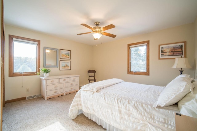 bedroom with light carpet and ceiling fan