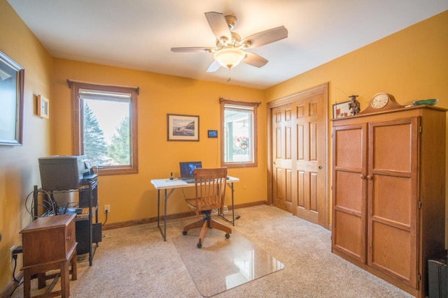 office space featuring light colored carpet and ceiling fan