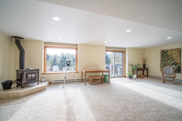 interior space featuring a baseboard heating unit and a wood stove