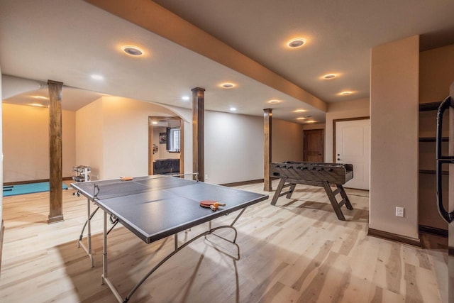 recreation room featuring decorative columns and light hardwood / wood-style flooring