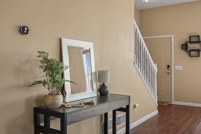 foyer entrance with dark hardwood / wood-style floors