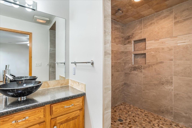 bathroom featuring vanity and a tile shower