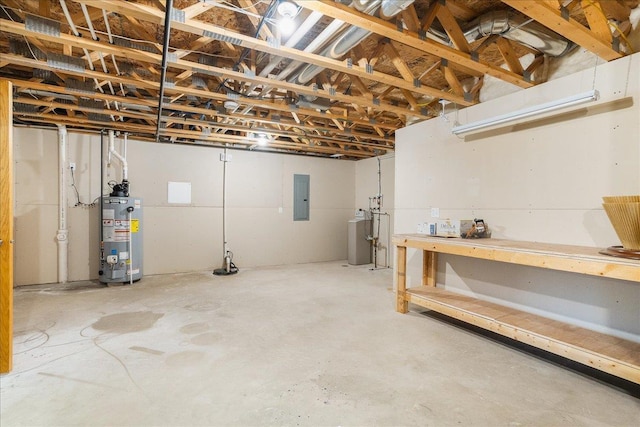 basement featuring electric panel and water heater