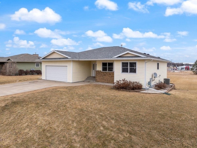 ranch-style home featuring cooling unit, a garage, and a front yard