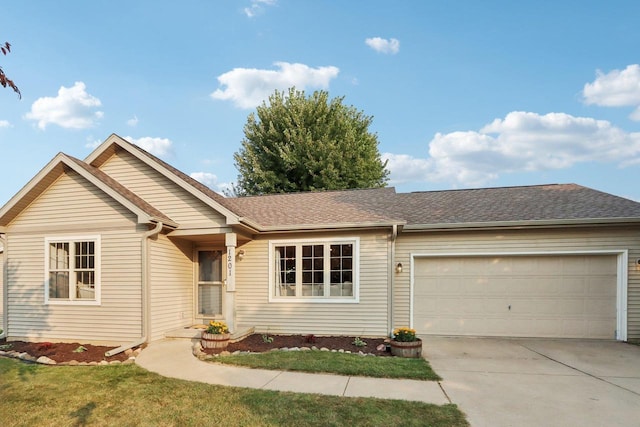 ranch-style house featuring a garage and a front lawn