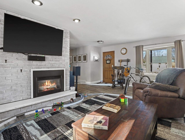 living room with hardwood / wood-style floors and a fireplace