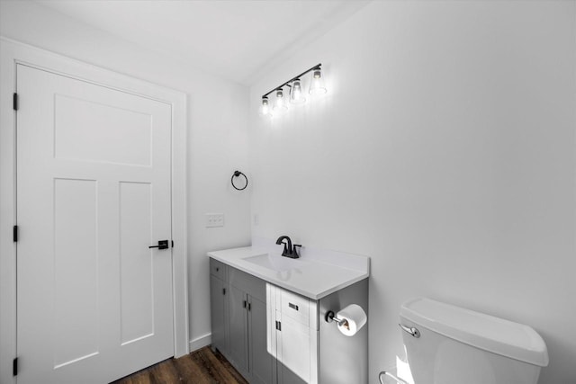 bathroom featuring hardwood / wood-style floors, toilet, and vanity