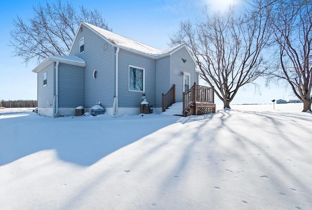 view of snow covered rear of property