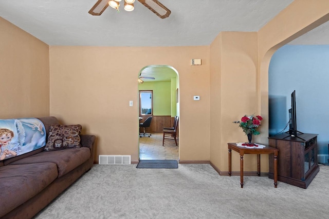 living room with ceiling fan and light colored carpet