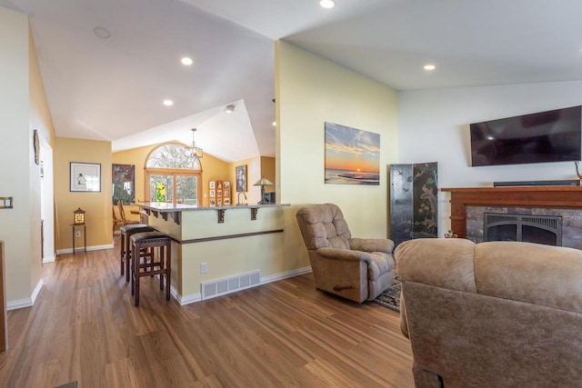 living room featuring vaulted ceiling and hardwood / wood-style flooring