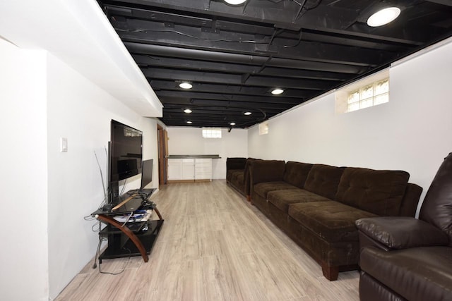 living room with plenty of natural light and light hardwood / wood-style flooring