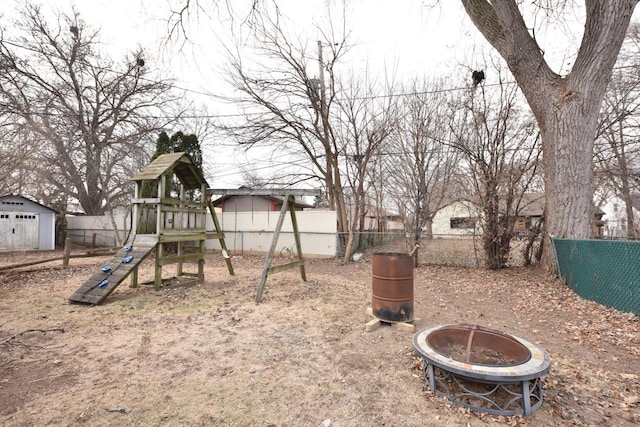 exterior space with a storage shed and an outdoor fire pit