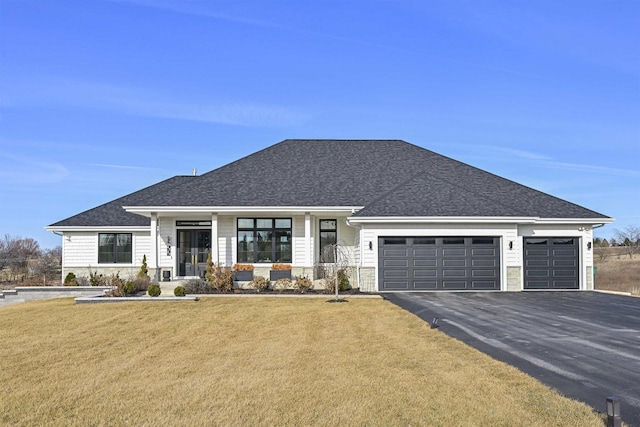 view of front facade with a garage and a front yard