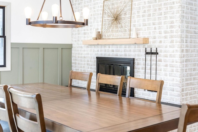 dining room featuring a brick fireplace