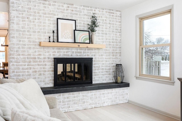 living room with plenty of natural light, hardwood / wood-style floors, and a fireplace