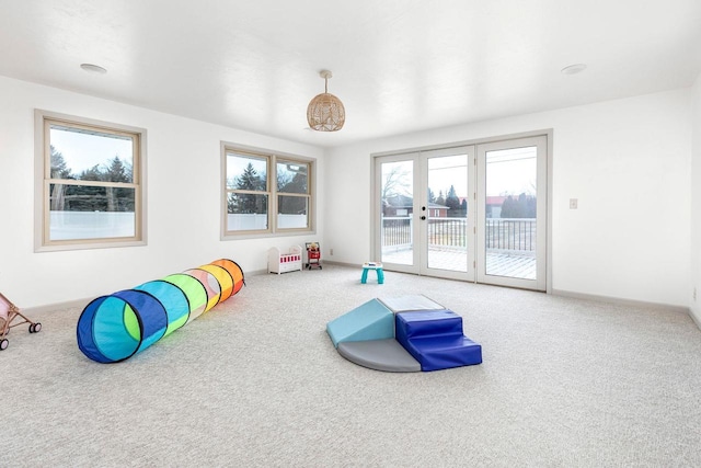 game room with carpet floors and french doors