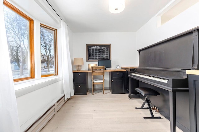 interior space featuring light hardwood / wood-style floors and baseboard heating