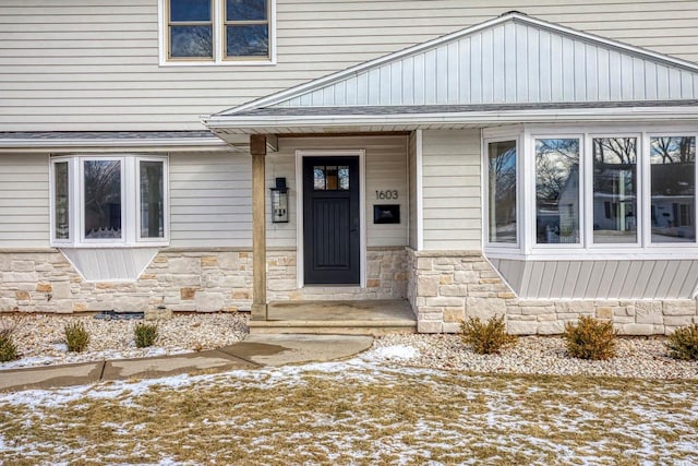 view of snow covered property entrance