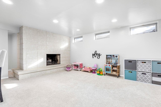 playroom with plenty of natural light, a fireplace, and carpet floors