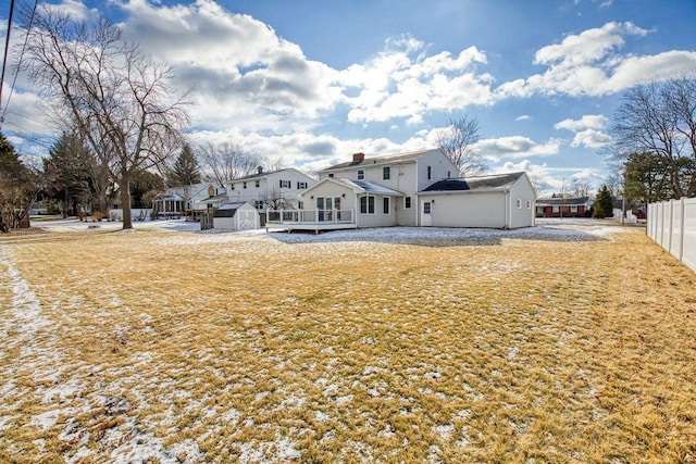 back of property featuring a yard and a storage unit