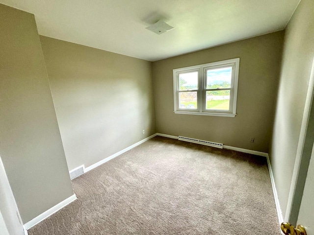 carpeted spare room featuring a baseboard radiator