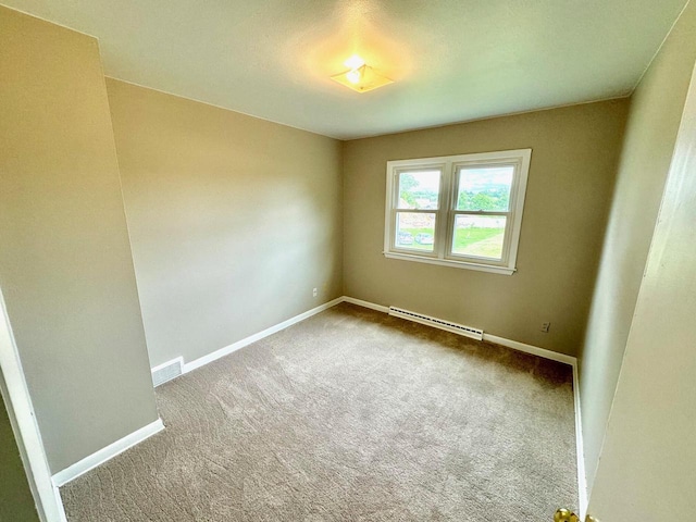 spare room featuring carpet floors and baseboard heating