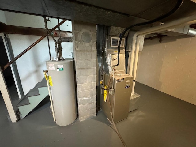 utility room featuring heating unit and water heater