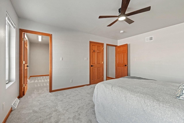 bedroom featuring light carpet and ceiling fan