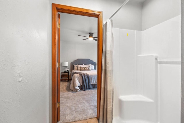 bathroom featuring ceiling fan and walk in shower