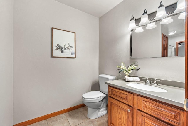 bathroom with tile patterned flooring, vanity, and toilet