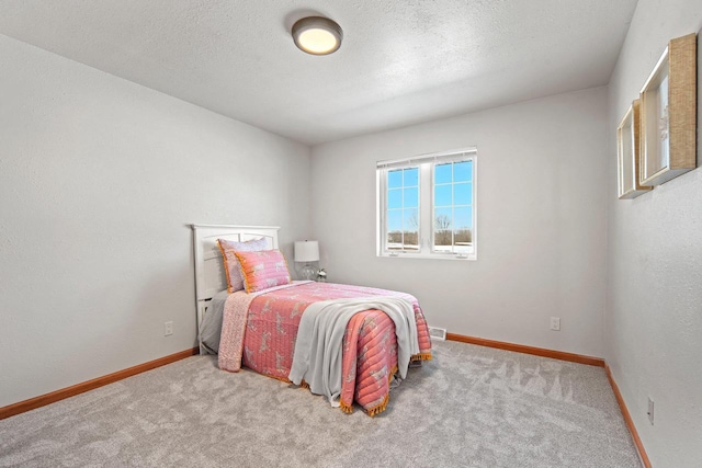 carpeted bedroom with a textured ceiling