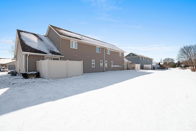 view of snow covered rear of property