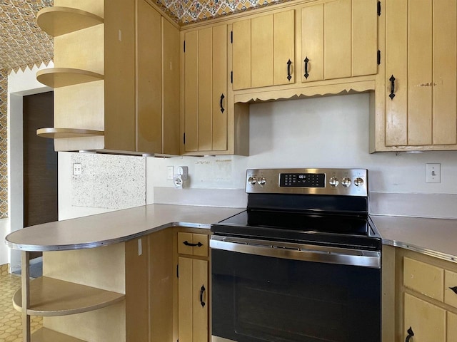 kitchen with electric stove and light brown cabinets