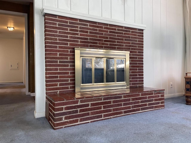 interior details with carpet floors and a fireplace