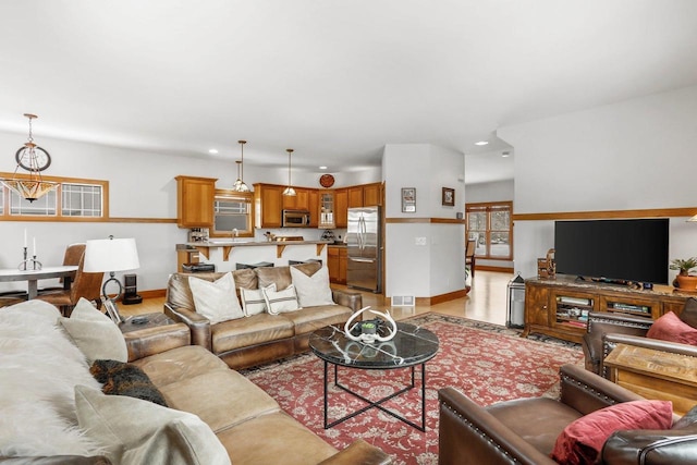 living room featuring a chandelier and sink