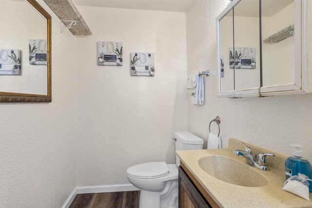 51 W 10th Ave, Oshkosh, WI 54902 - bathroom with wood-type flooring, vanity, and toilet