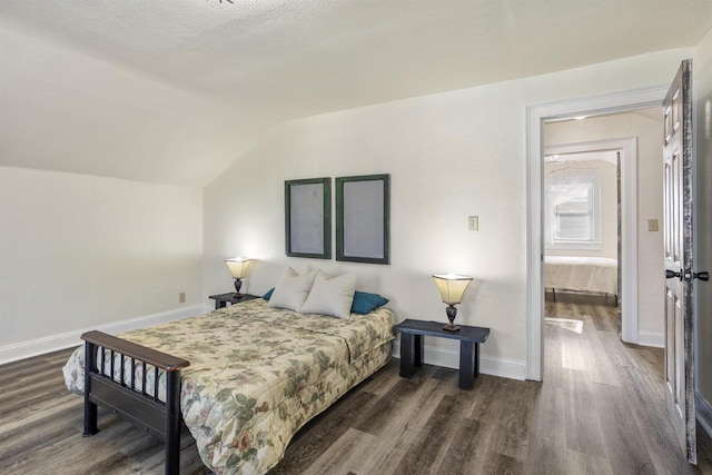 51 W 10th Ave, Oshkosh, WI 54902 - bedroom featuring vaulted ceiling and dark hardwood / wood-style floors