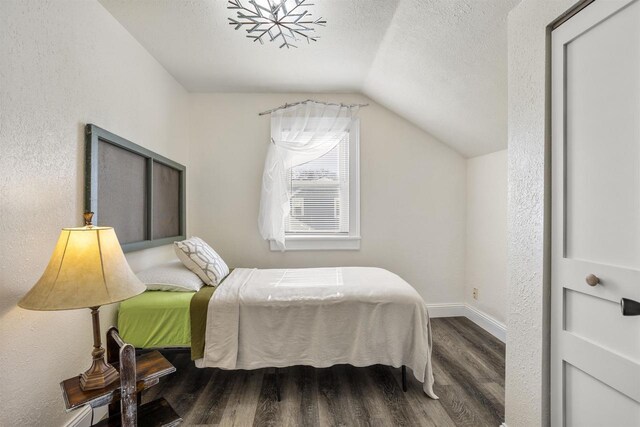 51 W 10th Ave, Oshkosh, WI 54902 - bedroom with lofted ceiling, hardwood / wood-style floors, and a textured ceiling