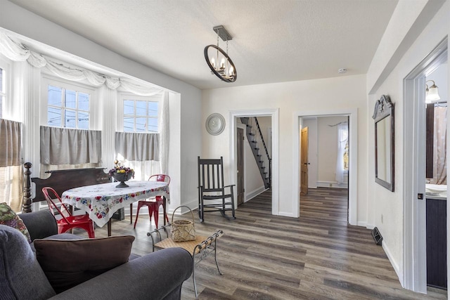51 W 10th Ave, Oshkosh, WI 54902 - living area featuring a textured ceiling, dark hardwood / wood-style floors, and a chandelier