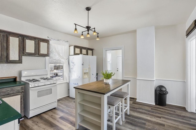 51 W 10th Ave, Oshkosh, WI 54902 - kitchen with pendant lighting, white appliances, dark brown cabinetry, and dark hardwood / wood-style floors