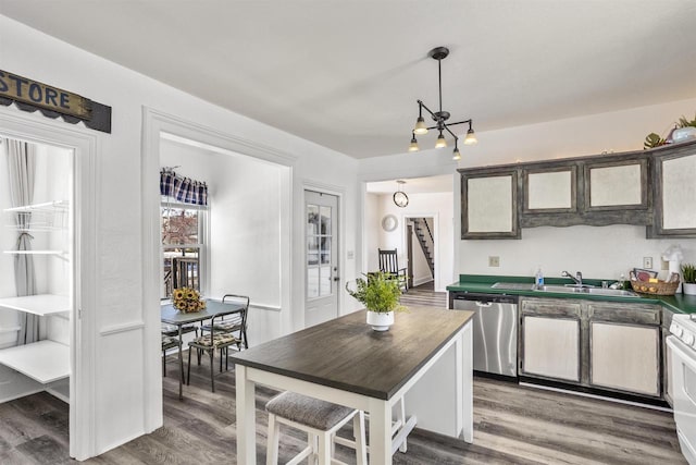 51 W 10th Ave, Oshkosh, WI 54902 - kitchen featuring pendant lighting, wood-type flooring, white range with gas cooktop, and dishwasher