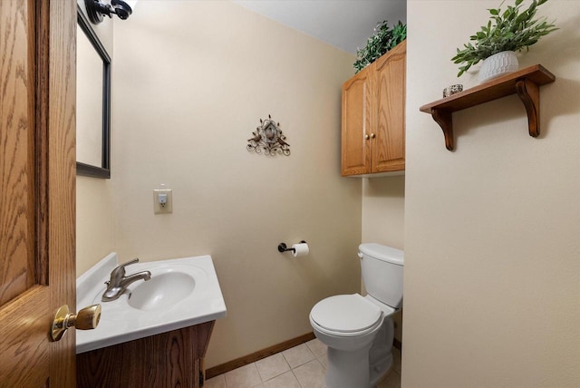 bathroom with vanity, toilet, and tile patterned flooring