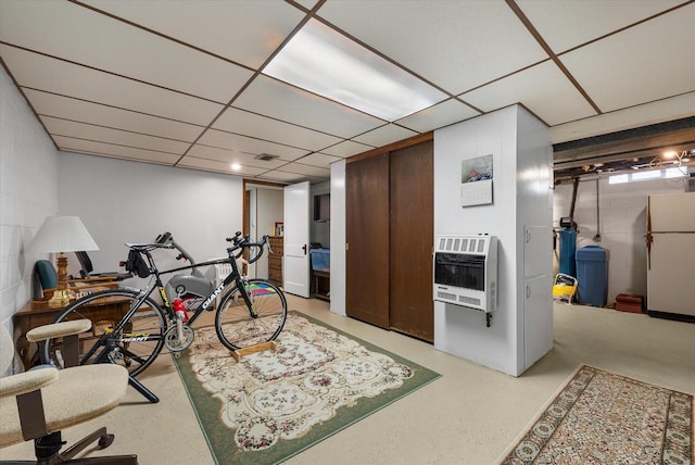 office area featuring heating unit and a drop ceiling