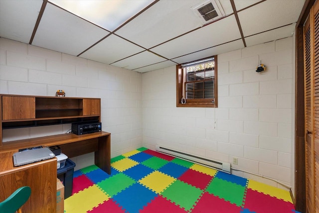 home office featuring a drop ceiling and a baseboard heating unit