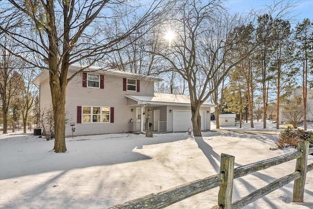 view of front property featuring cooling unit and a garage