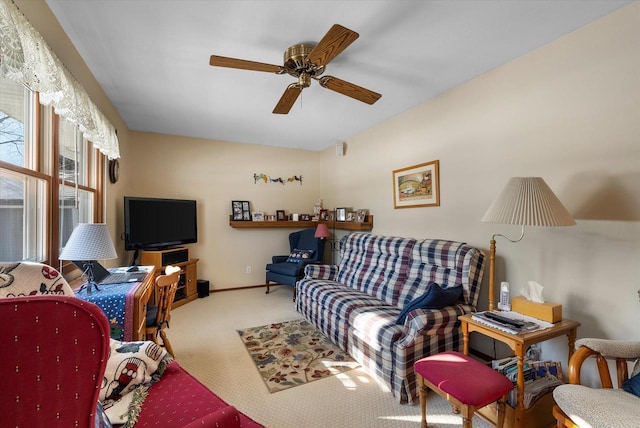 carpeted living room with ceiling fan