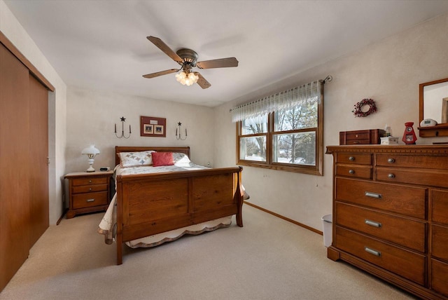 bedroom with light carpet, a closet, and ceiling fan