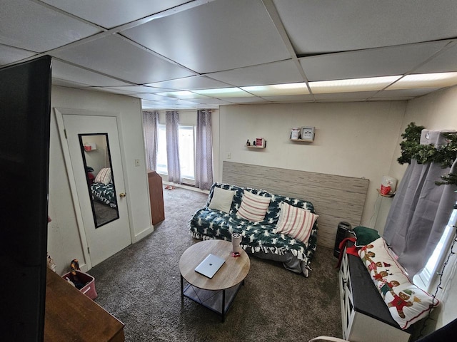 carpeted living room featuring a paneled ceiling