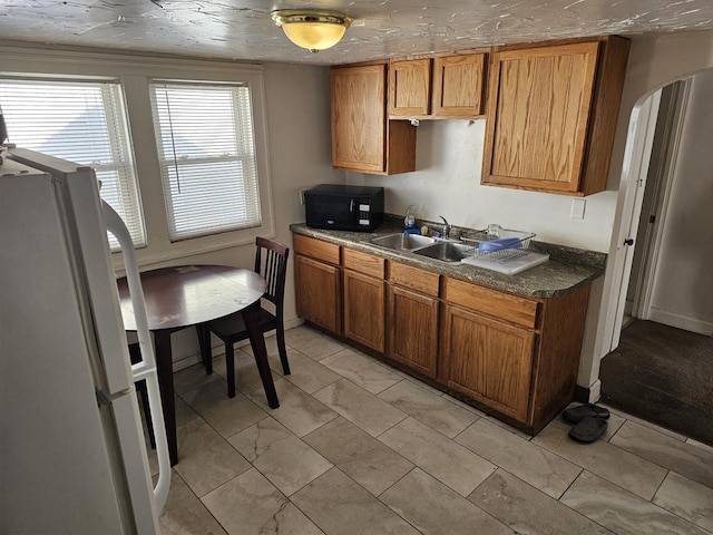 kitchen with sink and white fridge