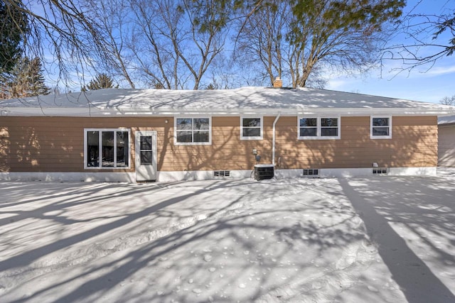 snow covered house with central AC unit